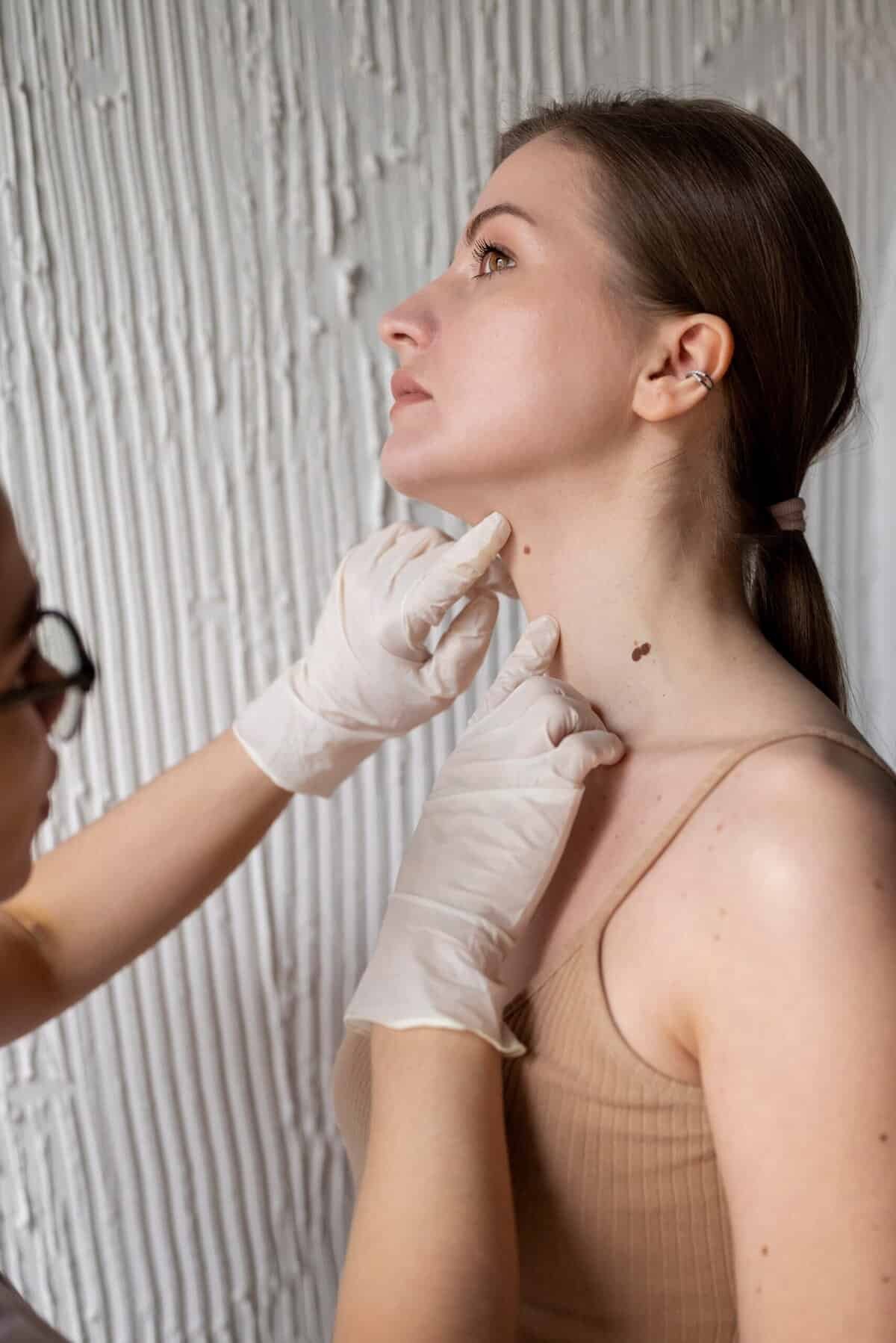 DHA-licensed dermatologist performing skin diagnosis at Sasha Aesthetic Clinic JVC Dubai